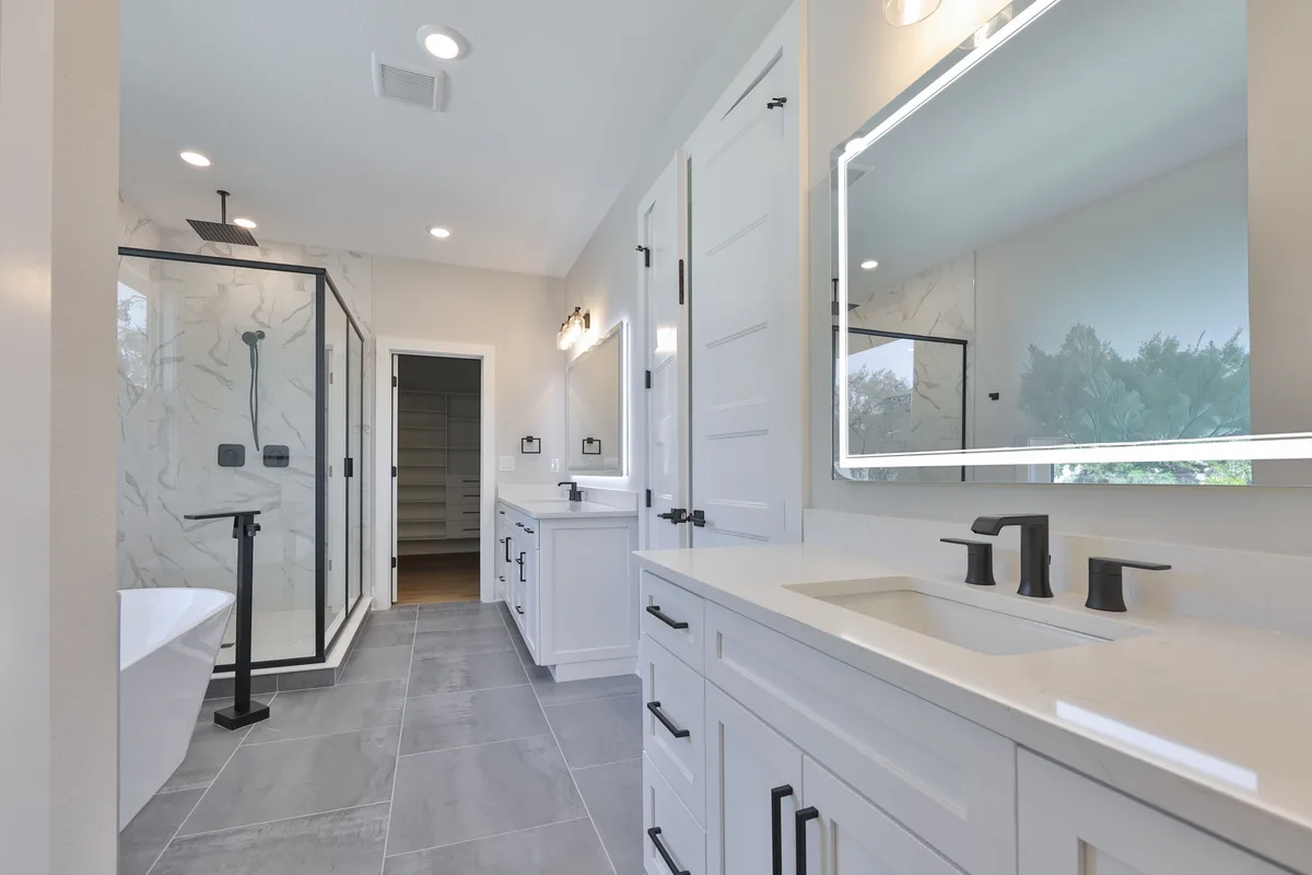 Primary bathroom with freestanding soaking tub, double vanity and walk-in shower
