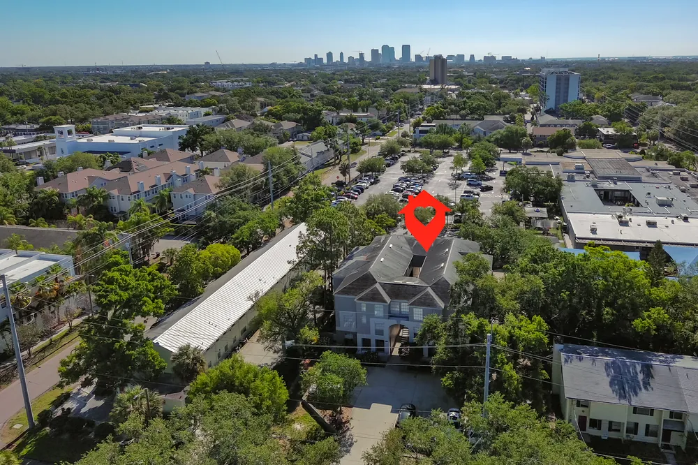 Aerial view of an attached home community in South Tampa with the city skyline behind it