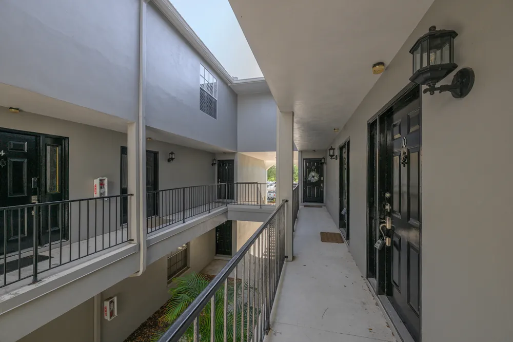 An open air walkway serving upper units, maintained by the association
