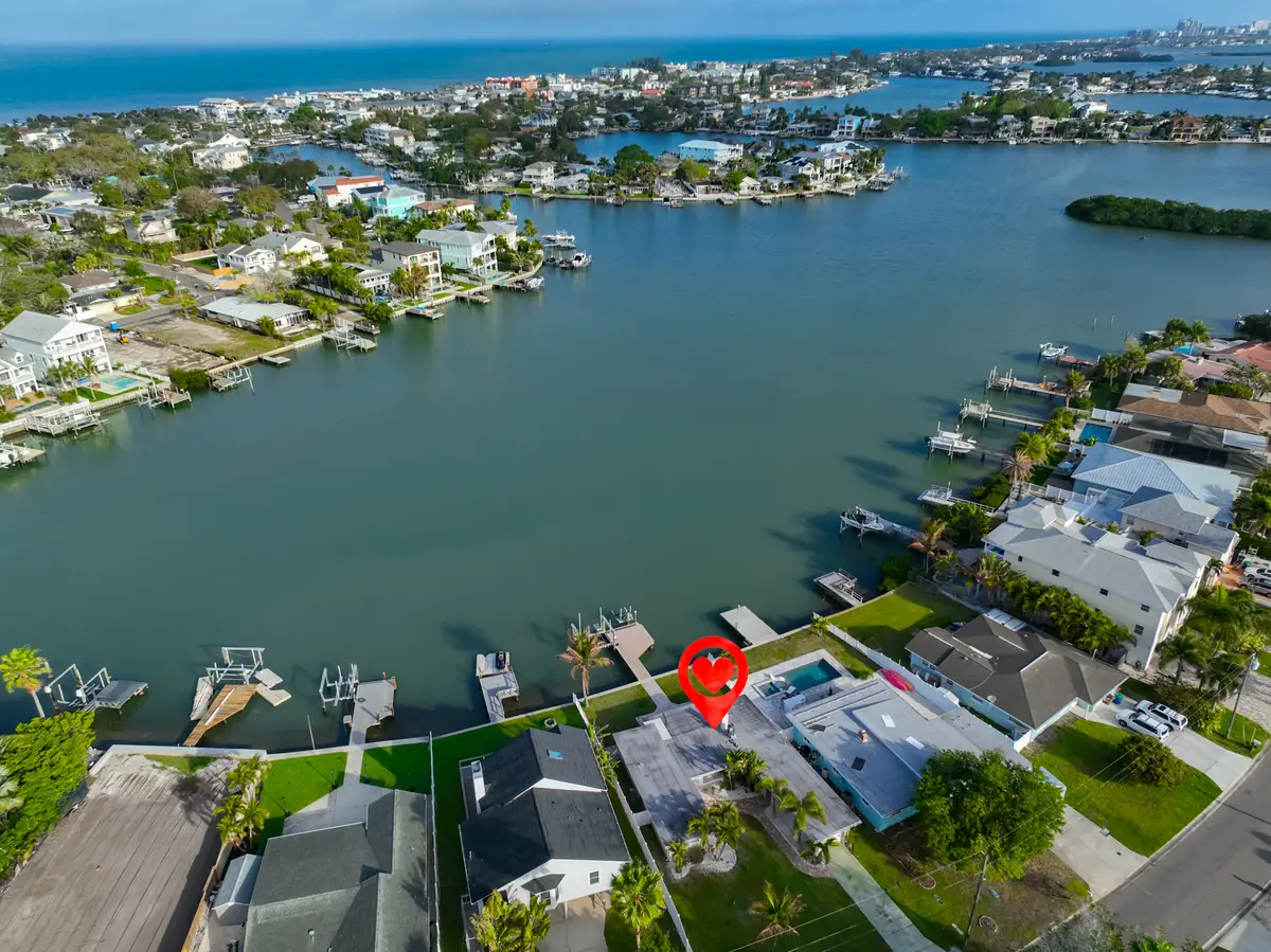 Aerial view showing the home's waterfront setting on a protected bayou with Intracoastal access.