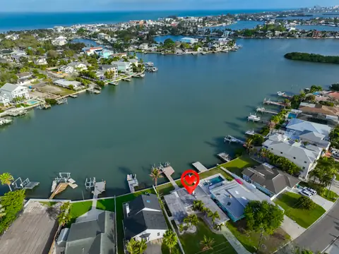 Aerial view showing the home's waterfront setting on a protected bayou with Intracoastal access.