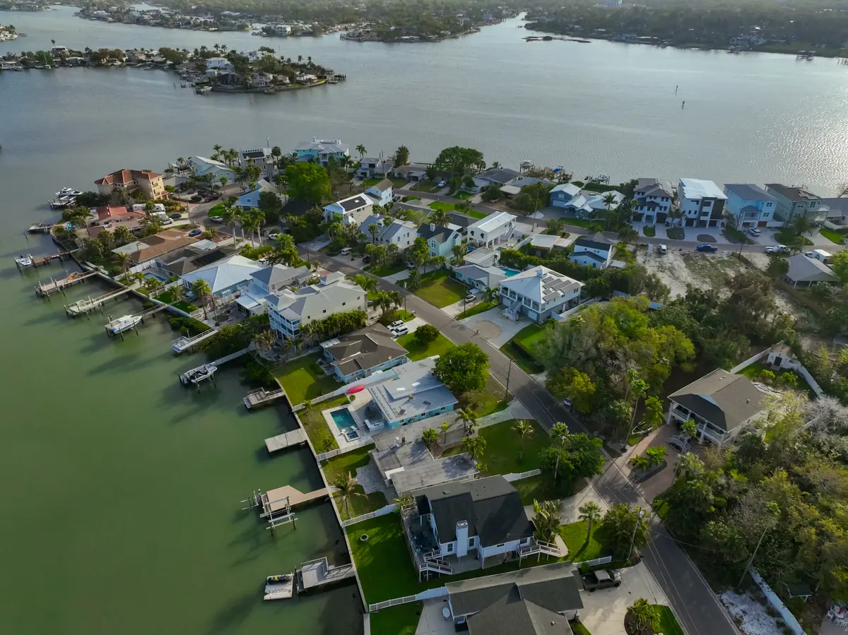 Golden-hour aerial showing a waterfront home's cul-de-sac location with panoramic views — drone photography by Kevin Freel