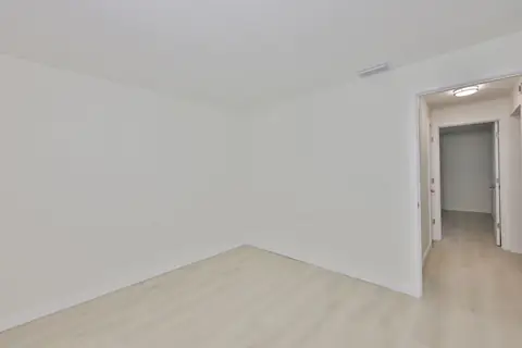 Second unit interior showing open living and kitchen area with uniform finishes.