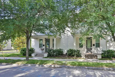 Secondary-angle exterior showing the symmetrical porch and entry columns.