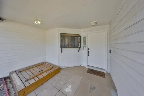 Covered front entry detail with hardy board siding and welcoming threshold.