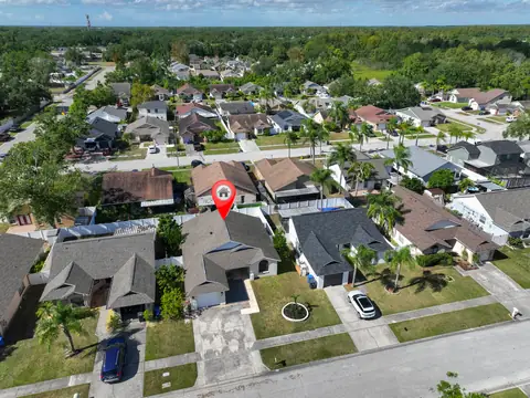 Overhead aerial of the home and its tree-lined Riverview neighborhood.