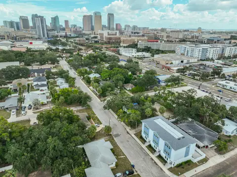 Lifted aerial view showing the townhomes with the downtown Tampa skyline as a backdrop.