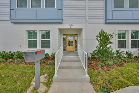 Bright entry and living area with white oak floors and abundant natural light.